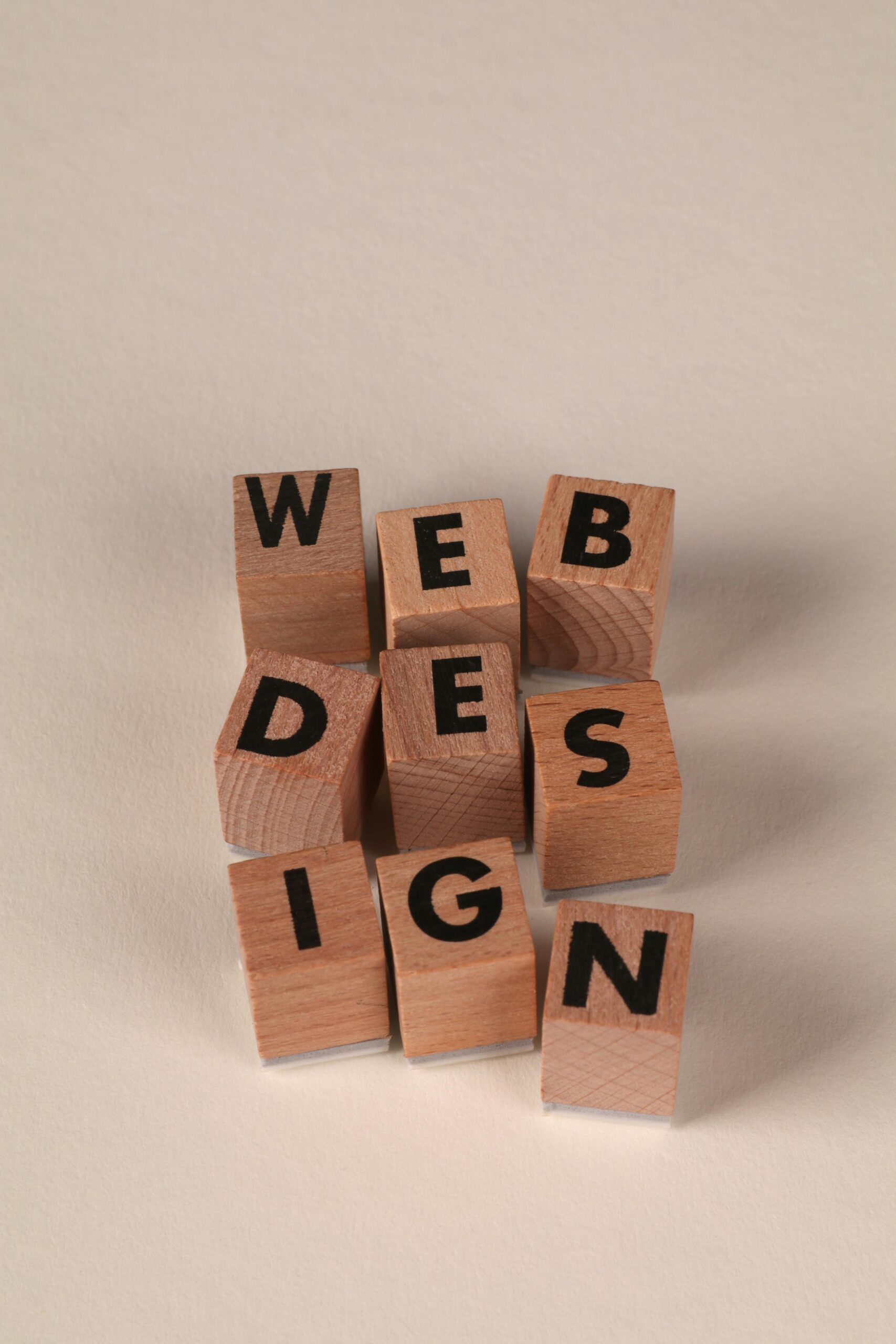 Wooden blocks arranged to spell 'Web Design'. Perfect for creative, digital content themes.